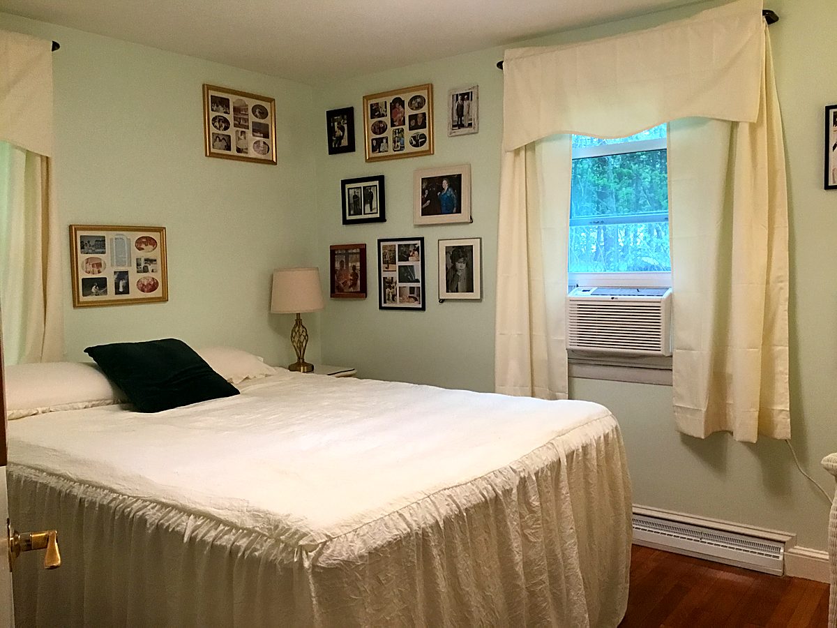 Finished bedroom with fresh paint, new bedding, and staged decor